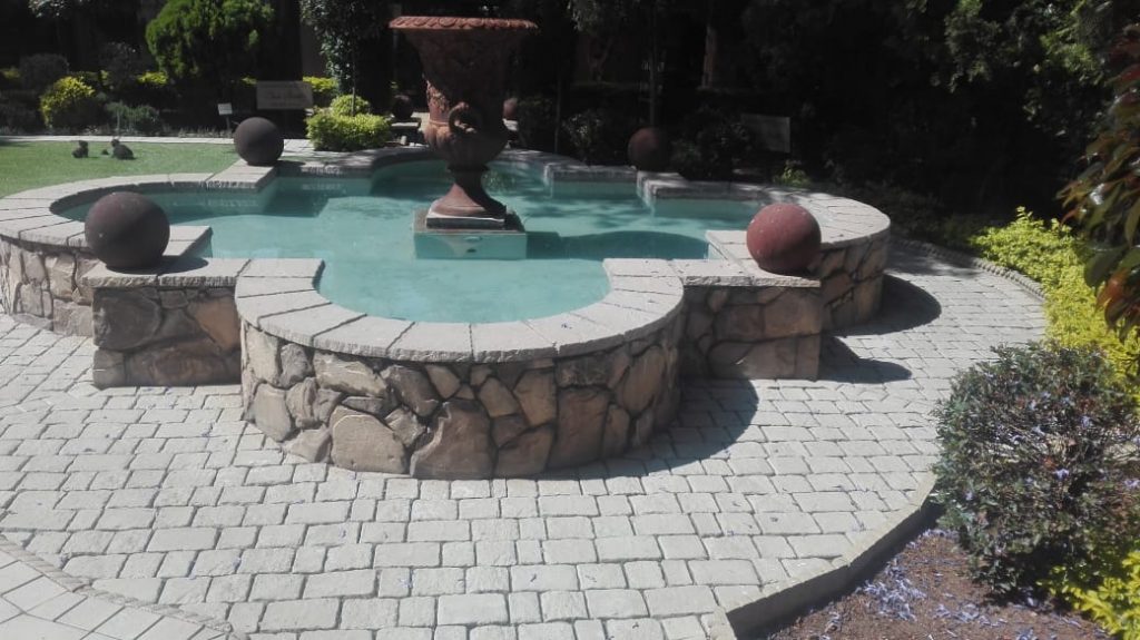 swimming pool with stone wall with stone works by newlands building projects